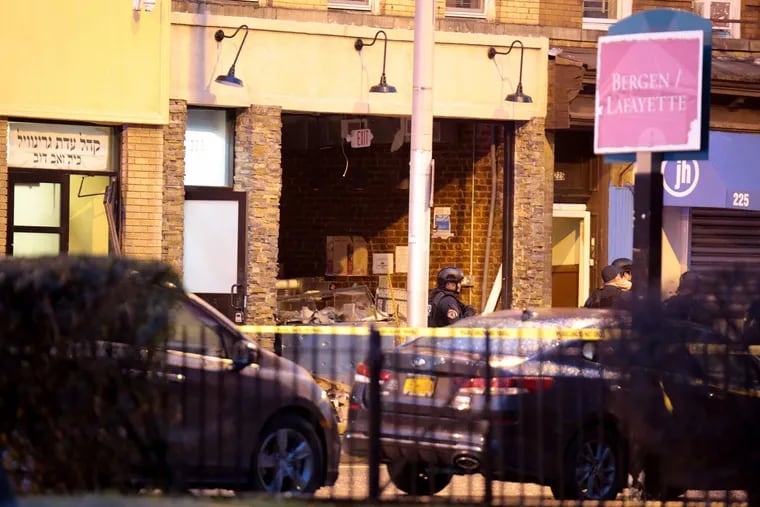 A  kosher grocery store with its front blown out is seen in Jersey City after a couple opened fire inside, killing at least three people on Tuesday, Dec. 10, 2019.