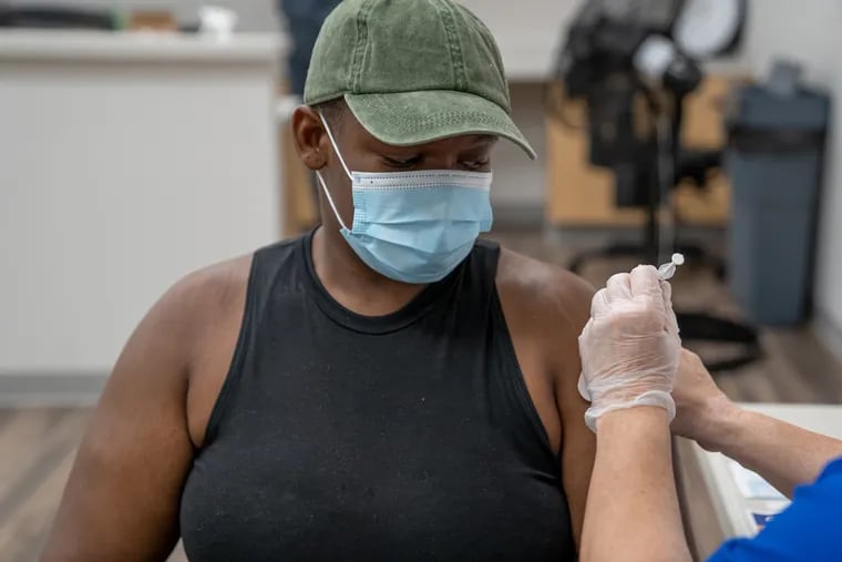 Lauren Pierre, 25, gets inoculated with the COVID-19 vaccine at Delaware County Wellness Center in Yeadon on Saturday. Pierre said she wanted to get vaccinated because she is going to work in a health-care profession.