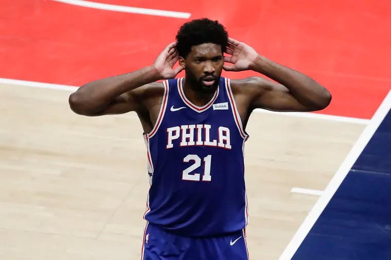Sixers center Joel Embiid taunts the Washington Wizards' fans after a second-quarter dunk in Game 3.