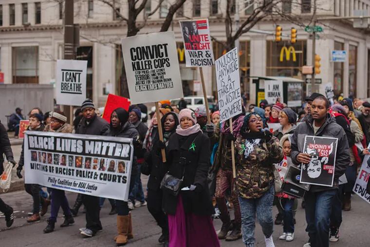 More than 5,000 people marched down Broad Street during the MLK Day of Action, Resistance, and Empowerment, Monday, Jan. 19, 2015. (CHRIS FASCENELLI/Staff Photographer)