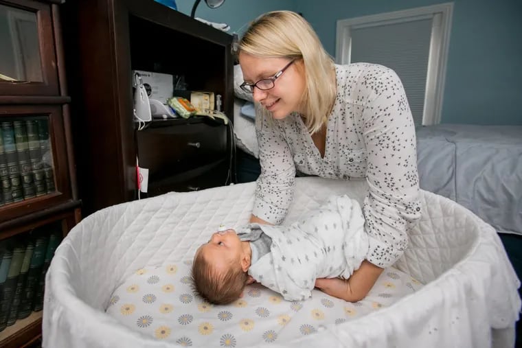 Rebecca Gidjunis of Manayunk lays her 7-week-year-old son, Gabriel, down in a bassinet next to her bed last fall.