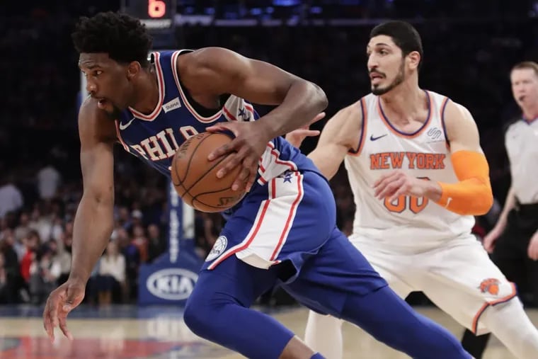 Sixers’ center Joel Embiid (left) drives past New York Knicks’ big man Enes Kanter during the Sixers’ win.