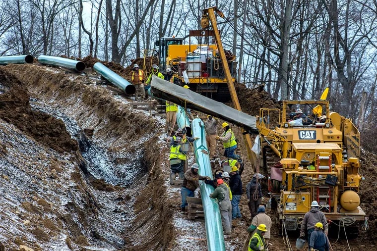 Workers lay a stretch of the Mariner East 2 pipeline in Washington County, Pa.