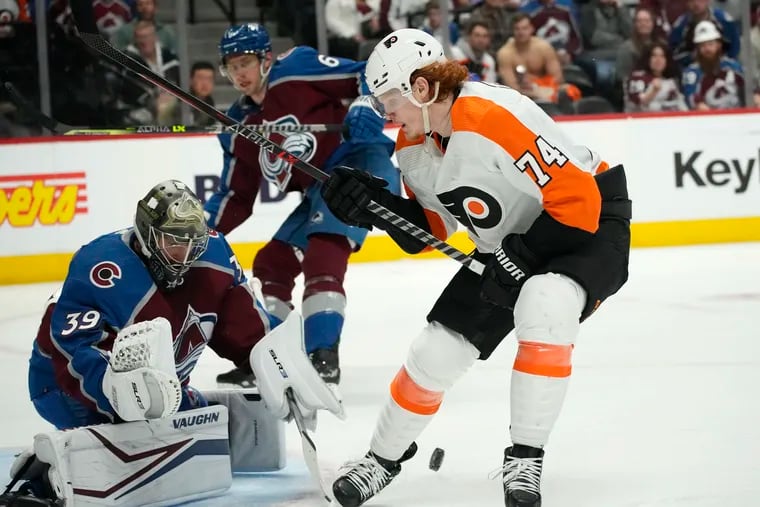 Philadelphia Flyers right wing Owen Tippett, right, has his shot stopped by Colorado Avalanche goaltender Pavel Francouz as defenseman Erik Johnson watches during the second period of an NHL hockey game Friday, March 25, 2022, in Denver. (AP Photo/David Zalubowski)
