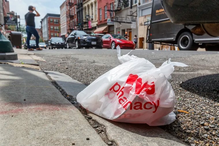 A discarded plastic bag filled with other plastic bags sits on the curb on Third Street in Philadelphia's Old City. A sweeping ban on single-use plastic bags was introduced in Philadelphia City Council in June.