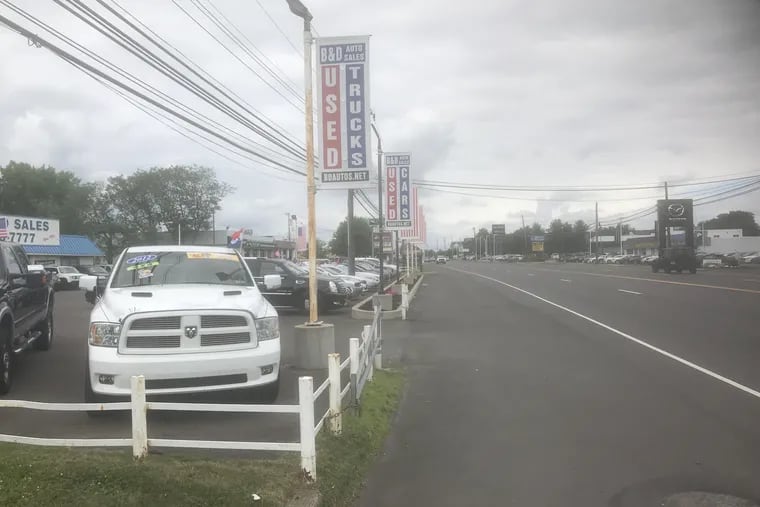 A used-vehicle dealership on Lincoln Highway in Lower Bucks. The county commissioners passed Pennsylvania's first county-level used-car lemon law in June.