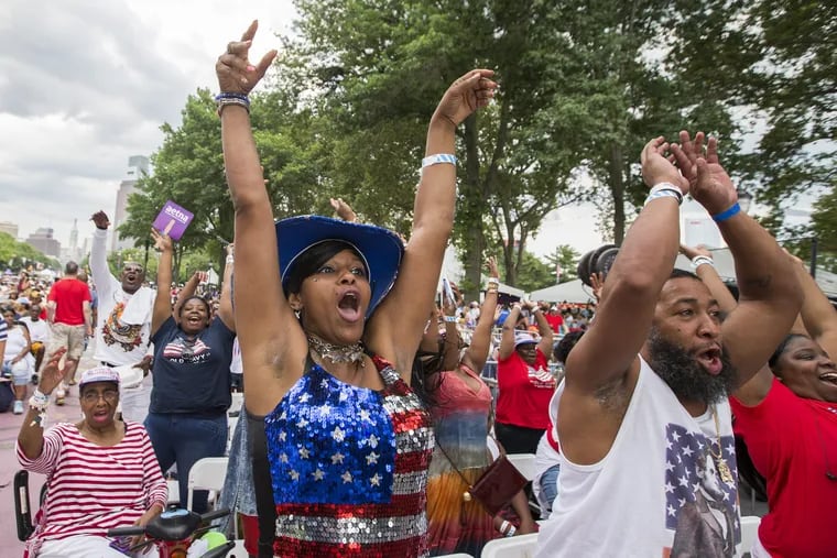 Esther Mobley, center, shows off some star-spangled spirit as the audience does the wave before the concert. Wawa Welcomes America 4th of July Concert and fireworks at the Philadelphia Museum of Art on July 4, 2017, featuring Mary J. Blige and Boyz II Men.