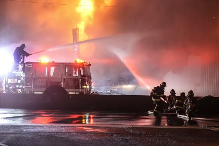 Firefighters battled a 4-alarm blaze Tuesday night in Pennsauken at a large commercial building at 6601 S. Crescent Blvd. that appeared to house an automobile auction business, October 26, 2021.