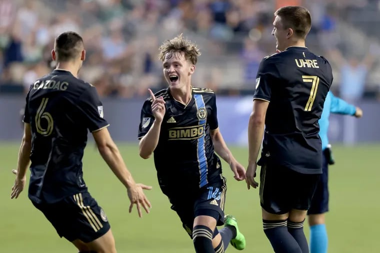 Jack McGlynn (center) celebrates after scoring his first MLS goal in a Union win over Houston last season.