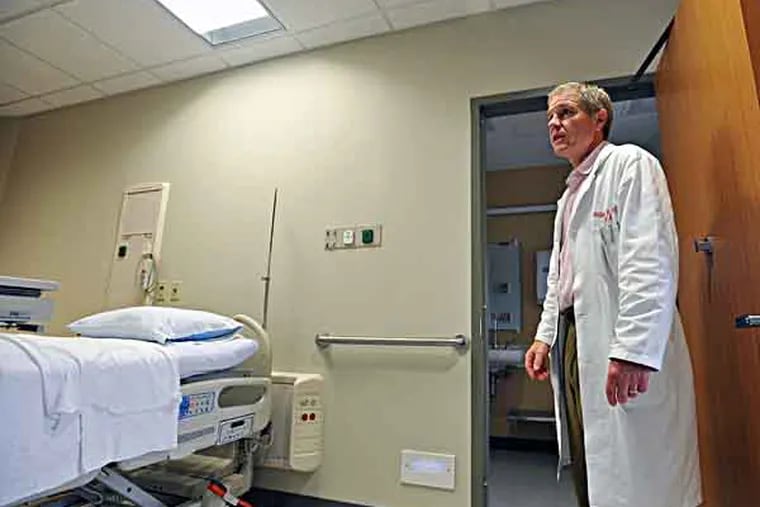 Paoli Hospital is opening a new Patient Care Pavilion. The rooms are all private. William Greer, doctor of Internal Medicine, stands by a handrail, leading from the bed to the bathroom that is in all the new rooms for patient safety. (Sharon Gekoski-Kimmel / Staff Photographer) June 4, 2009. Editors Note: PAOLI00. 3/5