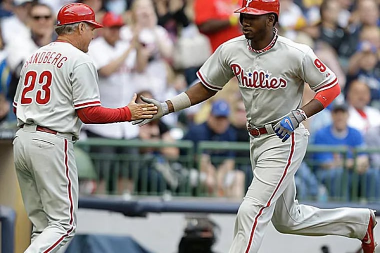 While Domonic Brown has seized his everyday spot in Charlie Manuel's lineup, the manager has three outfielders for two spots. (Jeffrey Phelps/AP)