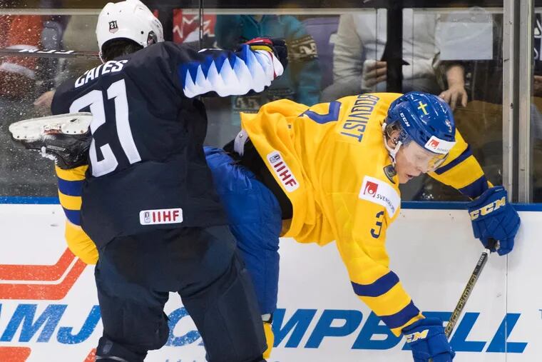The United States' Noah Cates (21), pictured checking Sweden's Adam Boqvist (3) into the boards in a game on Dec. 29, scored the opening goal in the U.S.'s win over the Czech Republic Wednesday at the World Junior Championship in Vancouver. (Jonathan Hayward / The Canadian Press via AP)