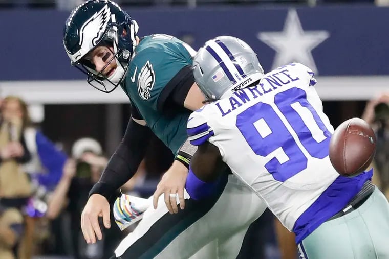 Eagles quarterback Carson Wentz fumbles the ball away on the Eagles' second possession after Cowboys defensive end DeMarcus Lawrence hit his arm. It was one of three turnovers by Wentz.