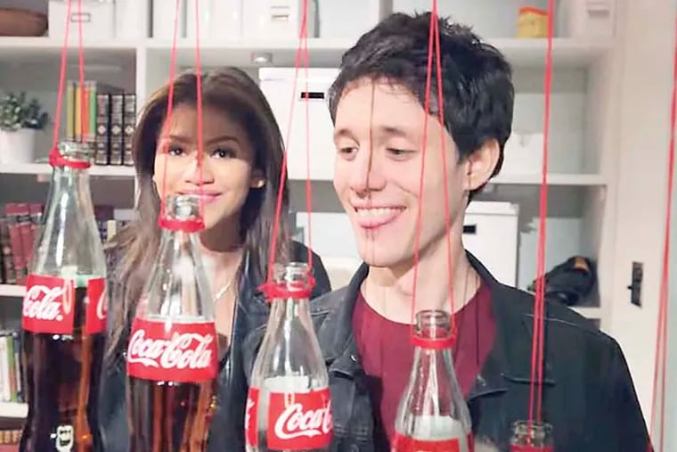 Zendaya, left, and Kurt Hugo Schneider at right (playing with bottles) in Kurt Hugo Schneider's YouTube video featuring a cover of “Safe and Sound” for Coca Cola http://youtu.be/7aEE_gAfyuA
