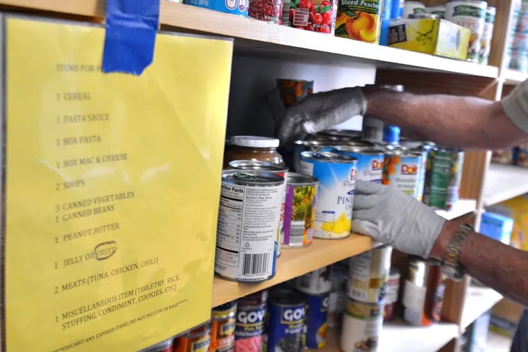 Donated canned goods line the shelves of the food pantry.
