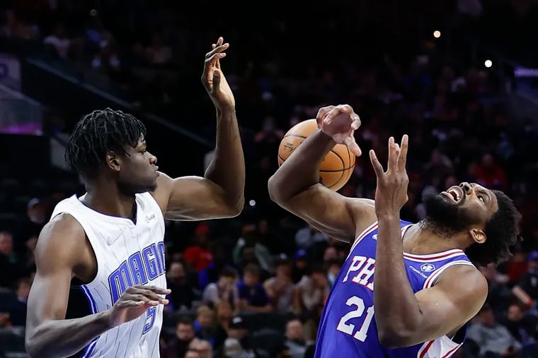 Sixers center Joel Embiid loses the basketball after getting fouled by Orlando Magic center Mo Bamba during the third quarter on Monday.