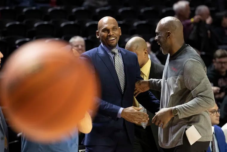 Temple coach Aaron McKie (right) of Temple greets Vanderbilt coach Jerry Stackhouse before their game at the Liacouras Center.