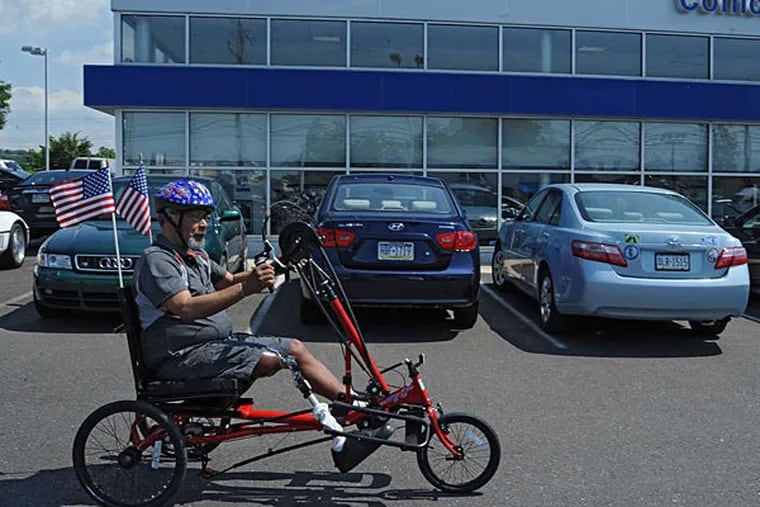 Ellwood &quot;Woody&quot; Allen of West Oak Lane takes his new trike for a spin in the parking lot of Conicelli Hyundai in Conshohocken. He will race it in the National Veterans Wheelchair Games in August. (Clem Murray/Staff)