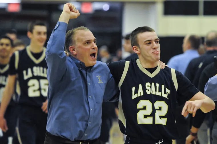 La Salle head coach Joe Dempsey celebrates after the Explorers beat Chester in PIAA Class 4A quarterfinal in 2014. Dempsey is out as coach at La Salle.