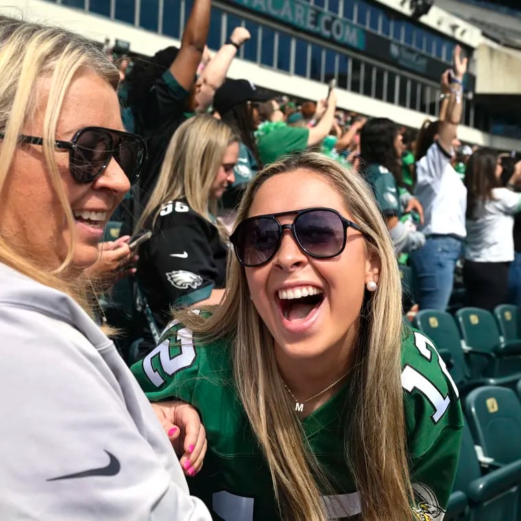 Madison Flythe (right), a senior at Clemson University, reacts with her mom Melinda Hall as former Eagle linebacker Jeremiah Trotter, Sr. arrives onstage at the Linc.  Flythe was a college classmate of Trotter’s son Jeremiah Trotter Jr., who was recently drafted by the Eagles.