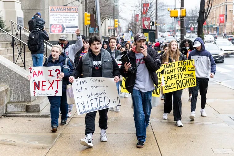 Greg Masters, of Bucks County, who studies jazz performance, leads chants as he marches along Broad Street with John Mangan, also of Bucks County, a senior finance major who founded Keep Us Safe Temple University. The group held a protest rally and march to call on the university to be more transparent about crimes and to improve its safety efforts.