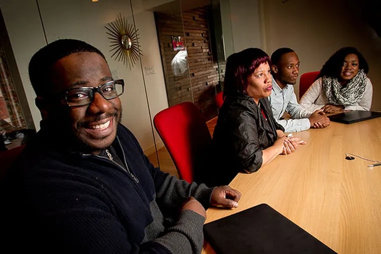 (From left) Instructor Tariq Hook and Temple University director of STEM education, outreach and research Jamie Bracey along with Temple freshman Iyasu Watts and Zuliesuivie Ball. Photograph taken on Tuesday, December 31, 2013 at a coffee shop on N. 31st St. in Brewerytown section of Philadelphia.  ( ALEJANDRO A. ALVAREZ / STAFF PHOTOGRAPHER )