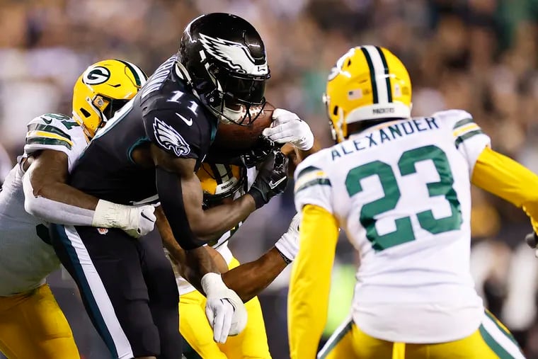 Eagles wide receiver A.J. Brown fumbles the football against Green Bay Packers linebacker Krys Barnes (left) with cornerback Jaire Alexander during the second quarter on Sunday, November 27, 2022 in Philadelphia.