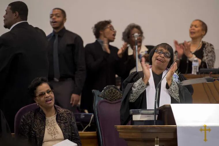 With the F.C. Wesley Methodist Church choir belting out a song in the background, Pastor Ralinda Goldback leads the congregation in a deconsecration ceremony.