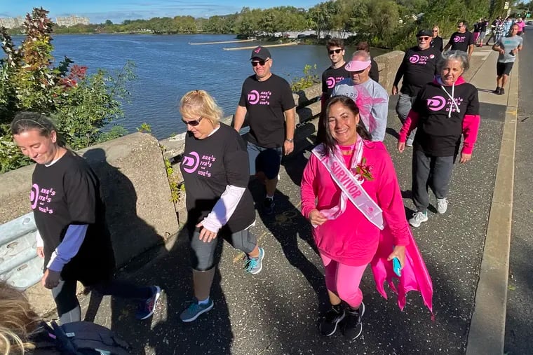 Dana Wheeler of Cherry Hill wears her survivor’s sash as she celebrates a decade cancer-free, joined by family and friends walking around the Cooper River. This was her 11th year walking in the American Cancer Society's Making Strides of Greater Philadelphia and Southern New Jersey annual fundraiser to help save lives and pay for the future of breast cancer research and programs.