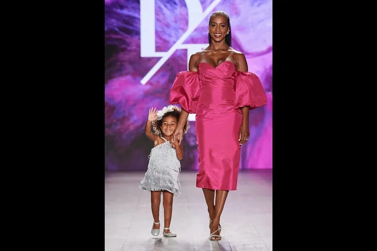 Amber-Joi Watkins and her daughter, Céline Domalski, walk the runway in the Double Take fashion show in New York.