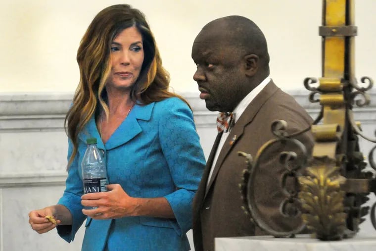 Pa. Attorney General Kathleen Kane talks with an agent from her office outside the Montgomery County courtroom during a break in her trial on Thursday, August 11, 2016.