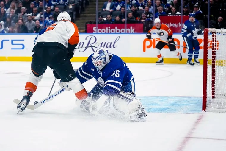 Flyers defenseman Travis Sanheim (6) is stopped by Toronto Maple Leafs goaltender Ilya Samsonov (35) during the first period of their game on Thursday.
