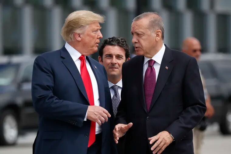 In this Wednesday, July 11, 2018, file photo, President Donald Trump, left, talks with Turkey's President Recep Tayyip Erdogan, as they arrive together for a family photo at a summit of heads of state and government at NATO headquarters in Brussels.