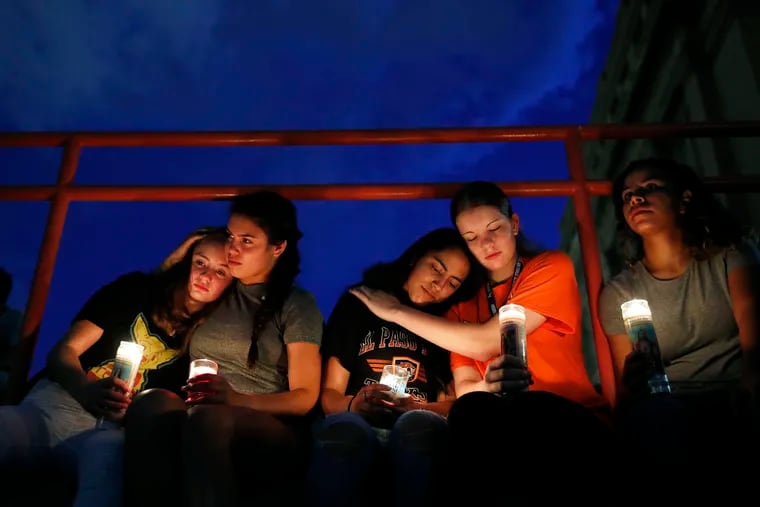 From left, Melody Stout, Hannah Payan, Aaliyah Alba, Sherie Gramlich and Laura Barrios comfort on another during a vigil for victims of the shooting Saturday in El Paso, Texas. A young gunman opened fire in an El Paso shopping area during the busy back-to-school season.