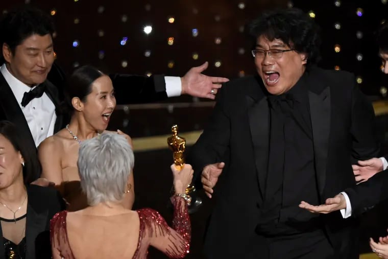 Bong Joon Ho (right) reacts as he is presented with the award for best picture for "Parasite" from presenter Jane Fonda. Looking on from left are Kang-Ho Song and Kwak Sin Ae.