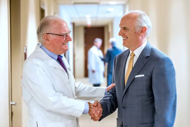 Richard Rothman (left), founder of the Rothman Institute, and Daniel J. Hilferty, president and chief executive of Independence Blue Cross, shake hands after signing a new, five-year insurance contract that makes Rothman part of Indpendence's facilitated health networks model.