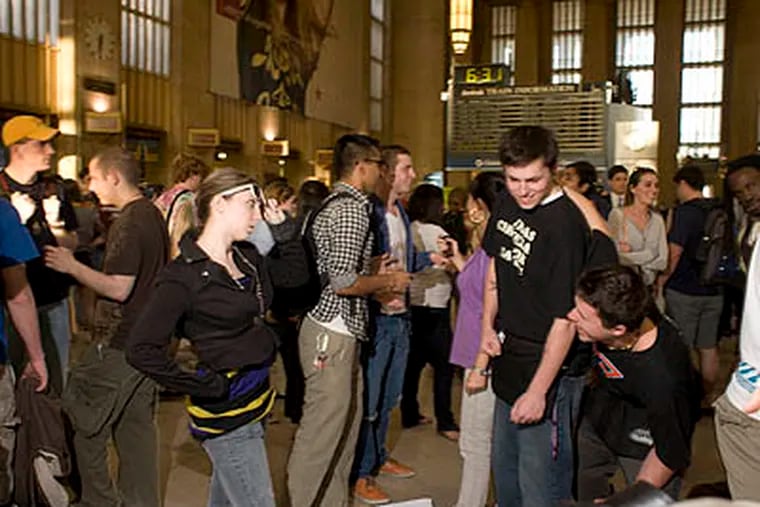 At precisely 6:30 p.m., a flash mob made up of 500-600 young people stopped in their tracks at Amtrak's 30th Street Station and froze in place for 3 minutes. The event, which was planned for three months, was peaceful. (Ed Hille / Staff Photographer)