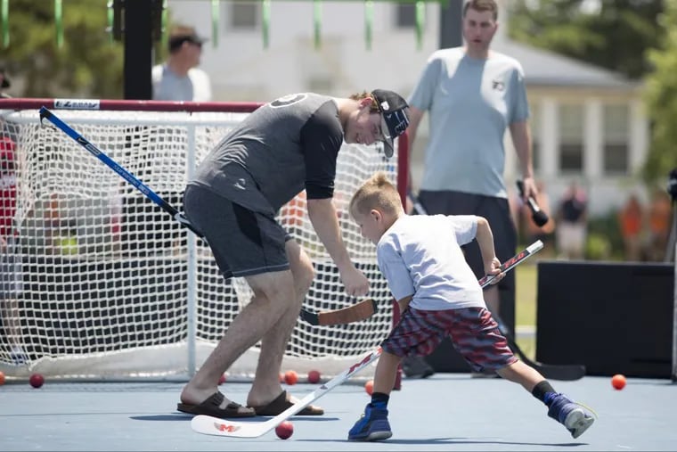 Flyers prospect Nolan Patrick plays goalie as Ryan Jacobs, 6, of West Chester, shoots at the event in Stone Harbor, N.J.