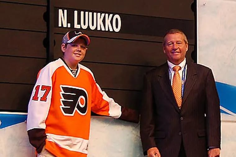 Flyers president Peter Luukko (right) and son Max (left) watched the Flyers draft Luukko’s older son Nick. (Photo by Zack Hill)