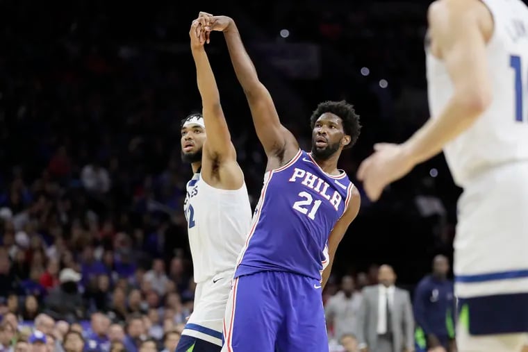 The Sixers' Joel Embiid makes a 3-pointer at the end of the first half, and the Timberwolves' Karl-Anthony Towns wants to hold hands at the Wells Fargo Center.