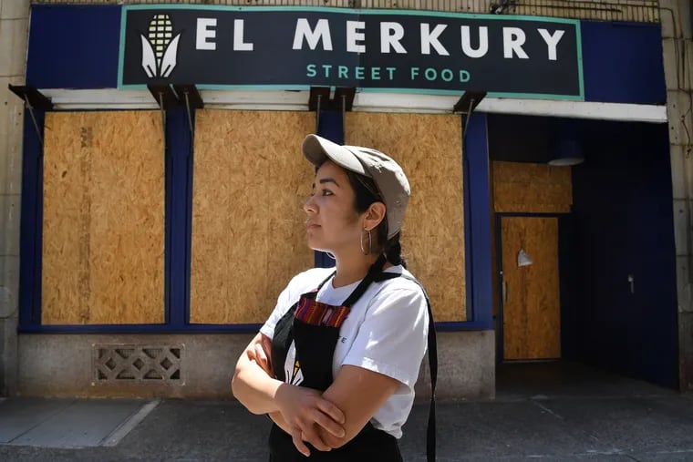 Sofia Deleon, owner and chef, in front of her boarded up restaurant, El Merkury in Philadelphia. Her restaurant was damaged by vandalism over the past week.