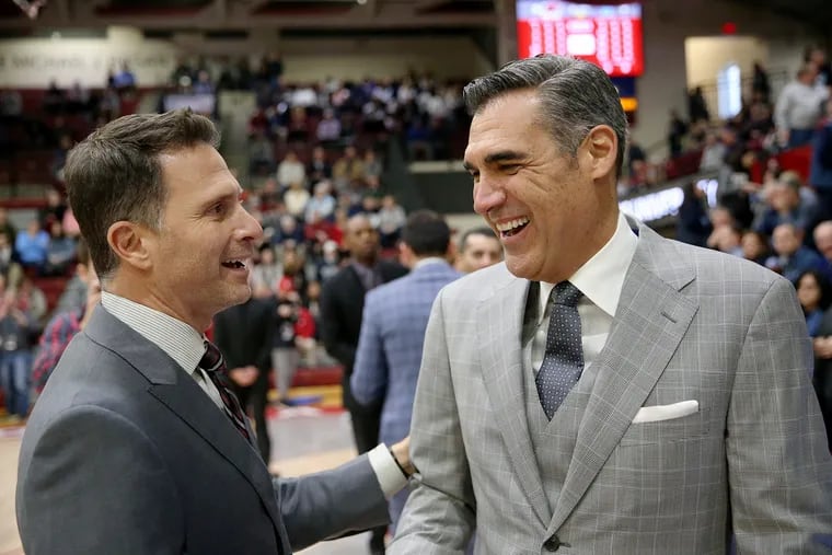 St. Joseph's head coach Billy Lange, left, greets Villanova head coach Jay Wright before a game at Hagan Arena in West Philadelphia last December. Their teams will go head-to-head again, albeit under much quieter circumstances this time around, on Saturday.