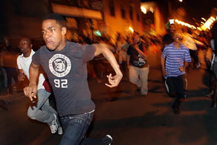 Youths rampage down South Street in 2010 in one of the incidents that prompted Philadelphia’s latest youth curfew. (Laurence Kesterson / Staff Photographer)