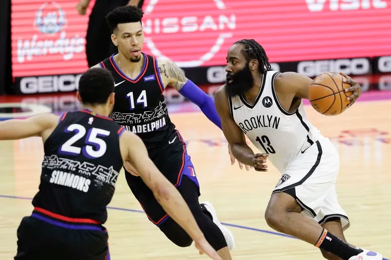 Sixers forward Danny Green and guard Ben Simmons defending Brooklyn Nets guard James Harden on Feb. 6, 2021 in Philadelphia.