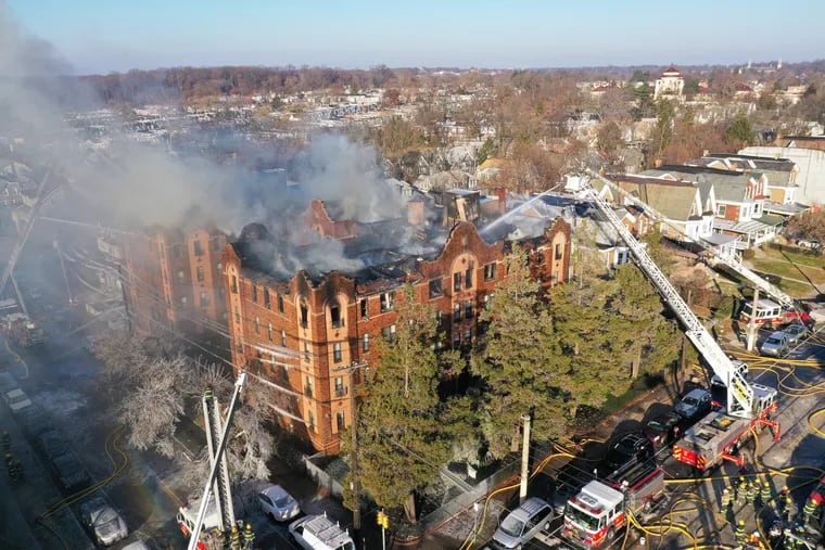 An aerial view shows the five-alarm fire in four-story apartment building at 63rd and Jefferson in the Overbook section of Philadelphia on Monday.