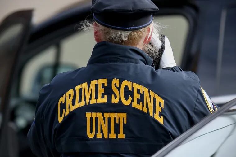 Philadelphia police investigate a crime scene in December. TIM TAI / Staff Photographer
