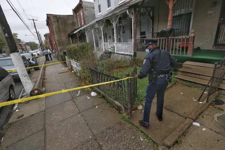 Philadelphia police investigate a double shooting on the 1100 block of West Somerset Street in North Philadelphia on Thursday in which a 32-year-old man was killed and a 4-year-old girl was injured.