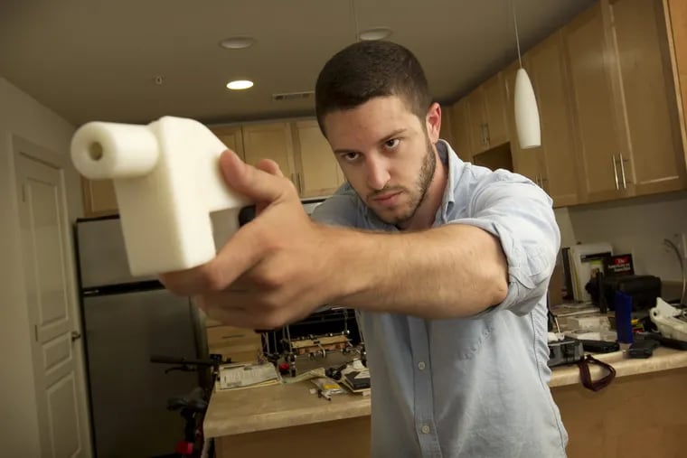 Cody Wilson shows the first completely 3D-printed handgun, The Liberator, at his home in Austin on Friday May 10, 2013. (AP Photo/Austin American Statesman, Jay Janner)