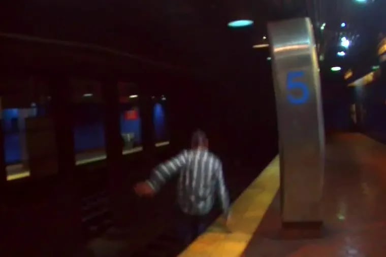 Image from video shows man jumping onto track area at the Market-Frankford Line station at 5th Street.
