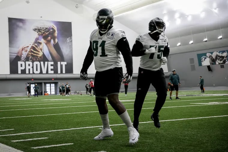 Vinny Curry (right) is reunited with Fletcher Cox. They entered the NFL together with the Eagles in 2012.